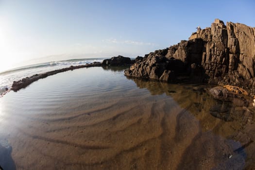Small Beach coastline rocky cove tidal pool for swimming surfing ocean waves landscape