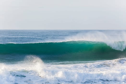 Ocean waves water crashing hollow energy power along rocky coastline.