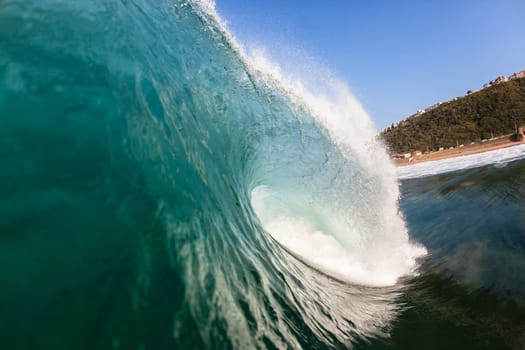 Ocean wave swimming inside crashing water power tube detail.