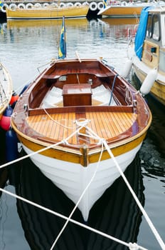 old beutiful open boat with motor and flag and shining