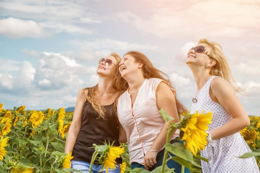 Three friends having a good time outdoors in a field