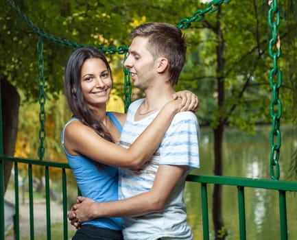 Happy young couple embracing in the park