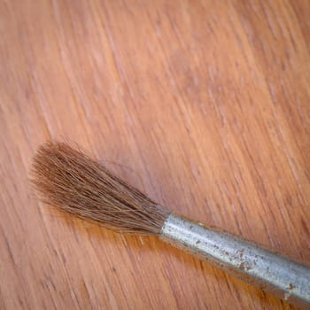 Brush tip on a wooden background