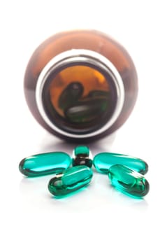 Pills capsule spilling out of a bottle, Selective focus