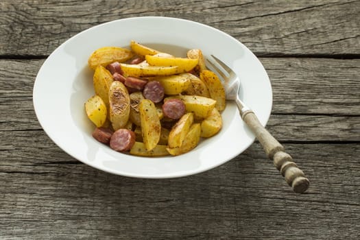 Plate with country potatoes and sausage
