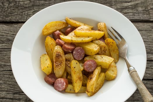 Top-plan country potatoes fried in a plate