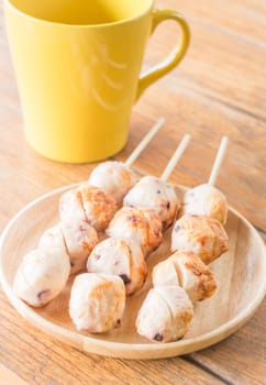 Squid grilled ball on wooden plate, stock photo