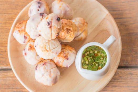Squid grilled ball on wooden plate, stock photo