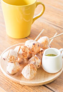 Squid grilled ball on wooden plate, stock photo