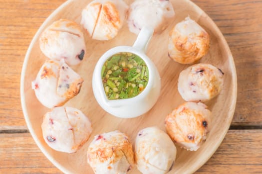 Squid grilled ball on wooden plate, stock photo