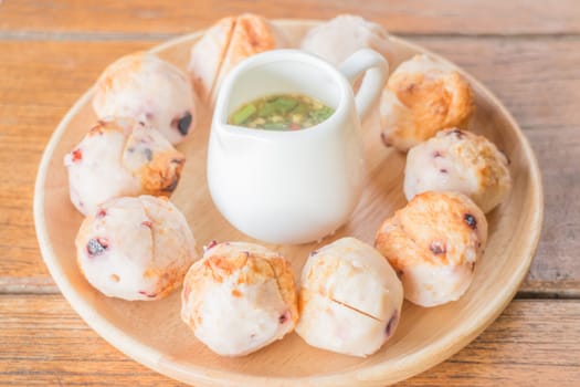 Squid grilled ball on wooden plate, stock photo