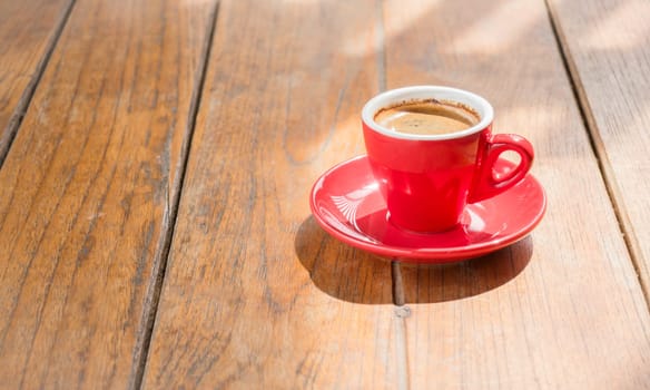 Hot coffee cup on wooden table, stock photo