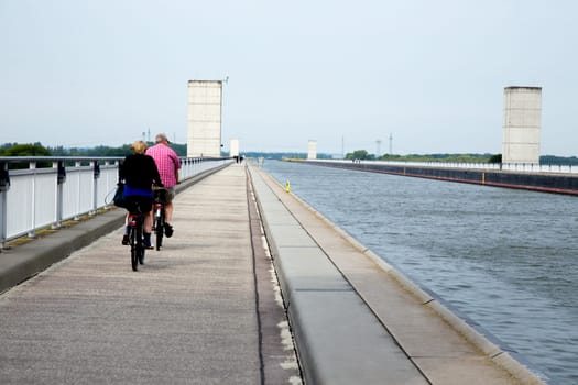 Two cyclists cross the bridge of the Elbe-Havel Canal over the Elbe