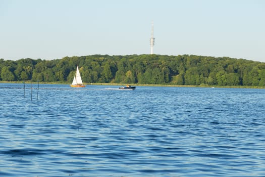 Sailing and motorboat on the Jungfernsee. TV tower in the background