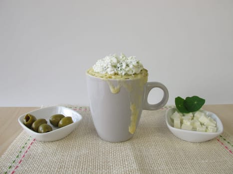 Mug Cake with olives,feta cheese and herbal quark topping