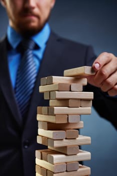 Business tower built by small wooden blocks