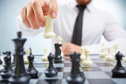Businessman with knight playing chess