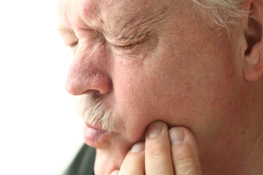 older man experiencing painful tooth