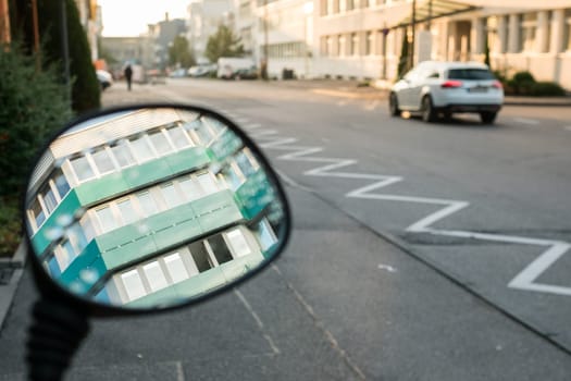 Office walls in the rear-view mirror in an industrial area