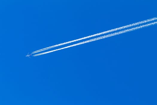 Jet Plane flying vapor white trail afternoon blue sky