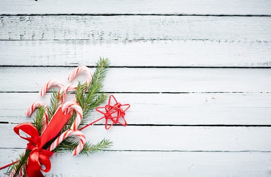 Christmas bouquet made up of candy canes, red star and conifer bound by red ribbon