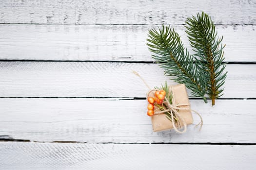 Small package and firtree conifer over wooden background