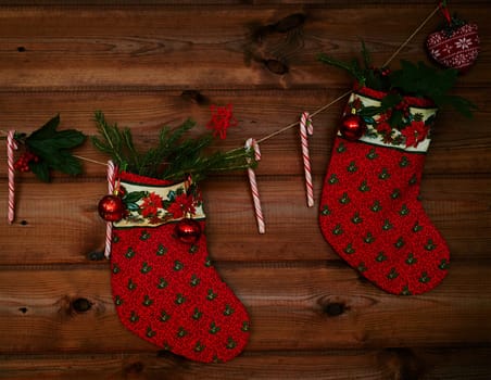 Christmas socks, sugar canes, toy bubbles and other decorations on wooden background
