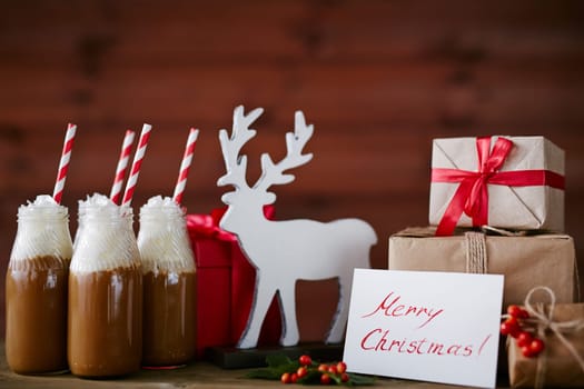 Toy deer, greeting card, hot chocolate with whipped cream and giftboxes