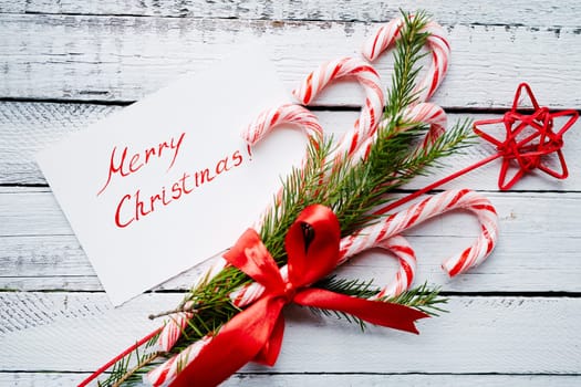 Christmas bouquet and greeting card on wooden background