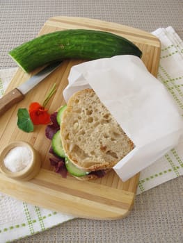 Cucumber sandwich in the takeaway butterbread paper bag