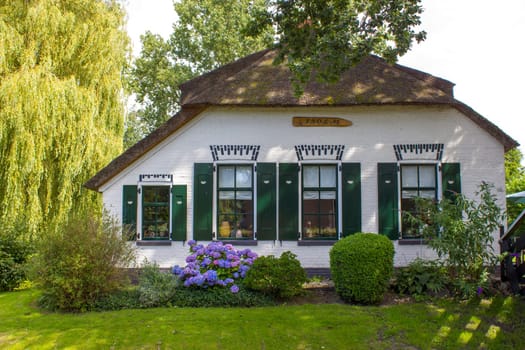 GIETHOORN, NETHERLANDS -typical dutch county side of houses and gardens