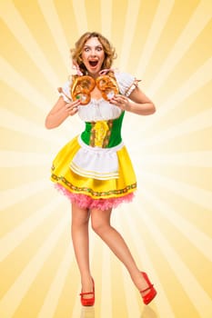 Happy excited sexy Oktoberfest woman wearing a traditional Bavarian dress dirndl holding two pretzels on colorful abstract cartoon style background.