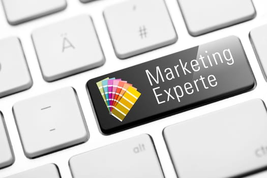 Marketing expert button on white keyboard with color compartments