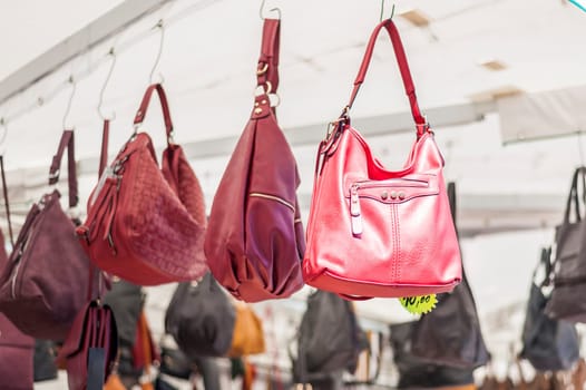 Women's handbags for sale at an outdoor market