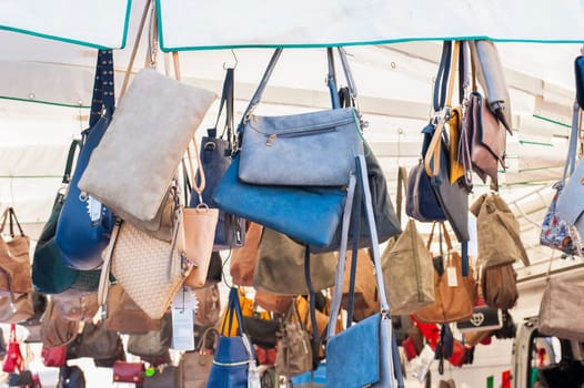 Women's handbags for sale at an outdoor market