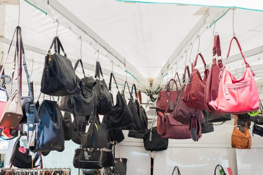Women's handbags for sale at an outdoor market