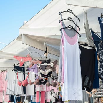 Clothes for sale at a local outdoor market. Italy