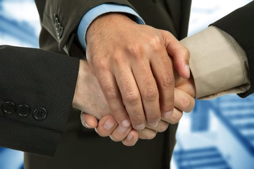 close up of three men hands together in a deal, studio picture