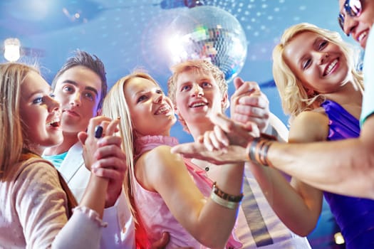 Three happy dancing couples enjoying party