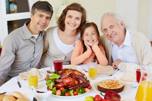 Happy family sitting at Thanksgiving table