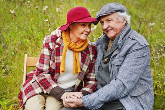 Retired seniors relaxing on green lawn