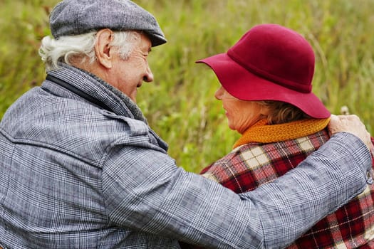 Back view of affectionate seniors interacting in natural environment