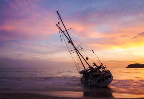 Boat on the beach side with color of sunset