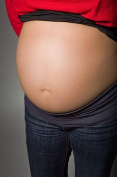 pregnant woman belly in a dark background