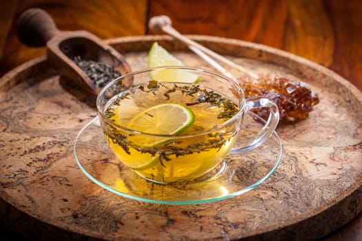 Cup of green tea with dried tea leaves