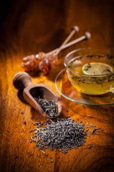 Dry green tea on wooden table
