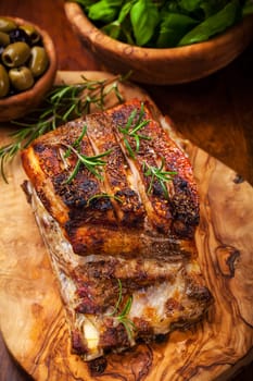 Roasted pork with herbs, olives and salad