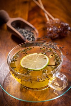 Cup of green tea with dried tea leaves