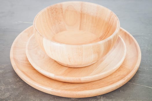 Wooden plate on grey background, stock photo