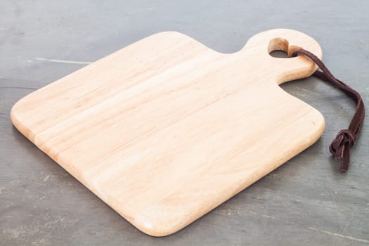 Wooden plate on grey background, stock photo